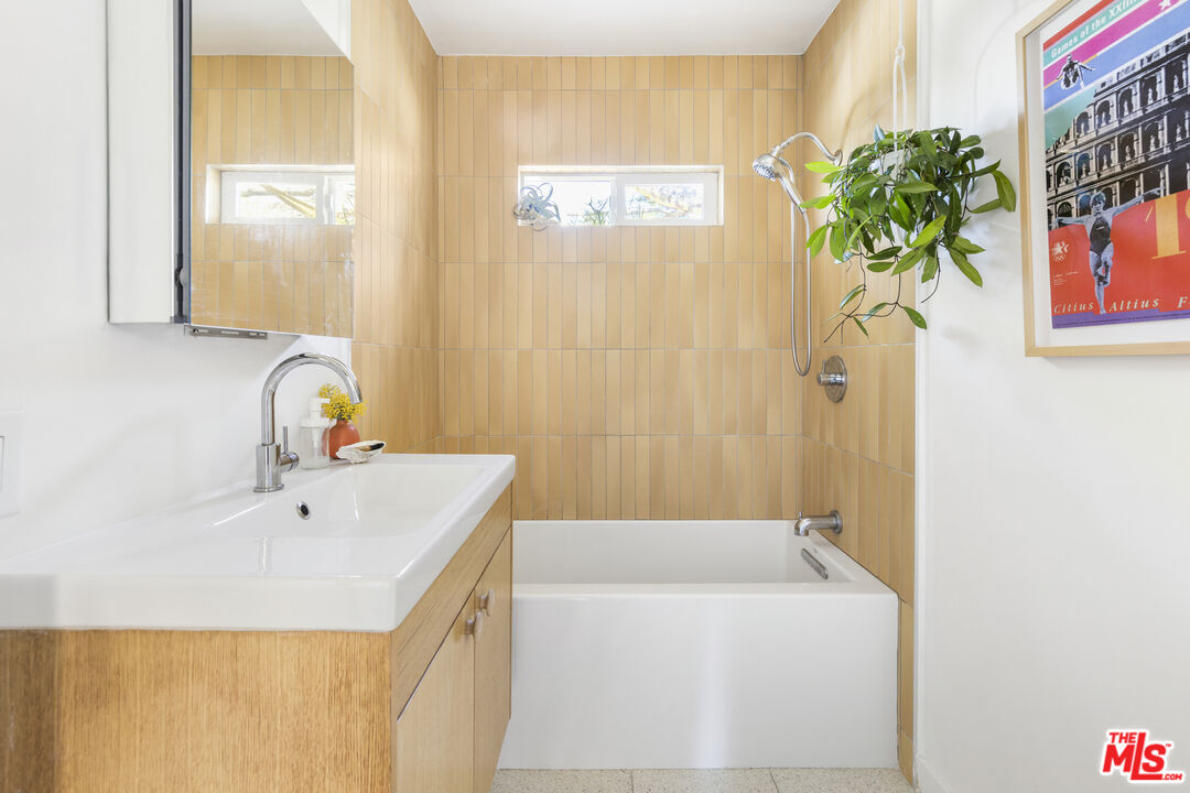 7543 Kyle Street Tujunga, CA 91042 - Photo 11 of 21 a bathroom with a sink a mirror and a shower