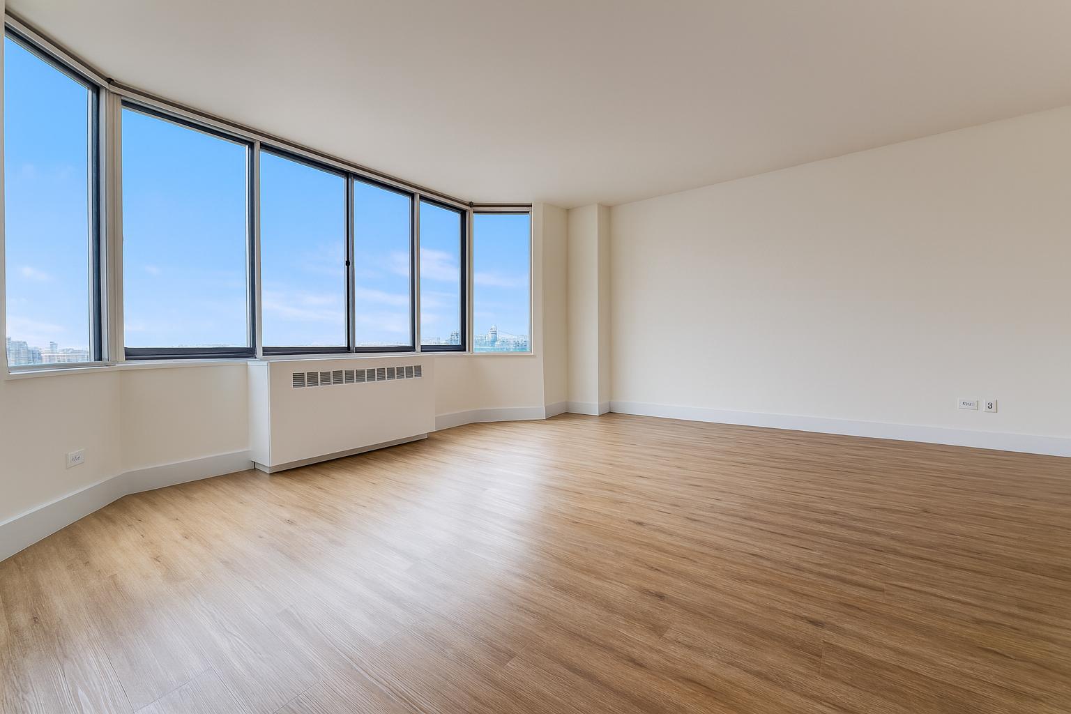1735 York Avenue, Unit 12H Manhattan, NY 10128 - Photo 7 of 23 a view of an empty room with wooden floor and a window