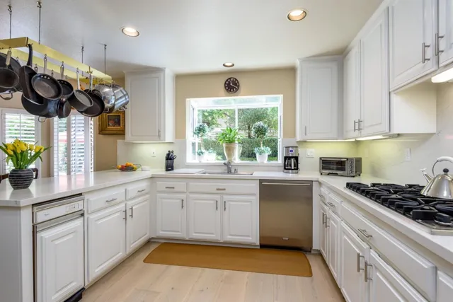 a dining room with furniture window and wooden floor