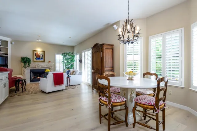 a view of a dining room with furniture and chandelier