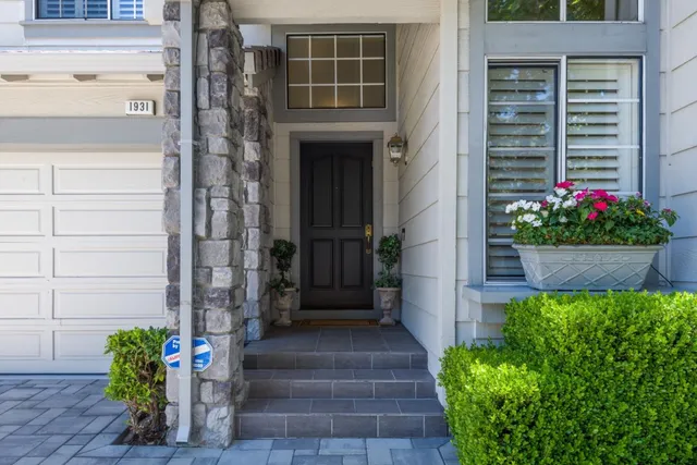 a front view of a house with a garden
