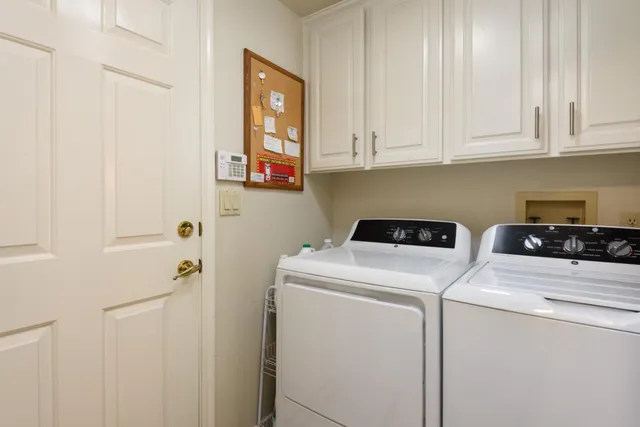 a view of a patio with a dining table and chairs under an umbrella