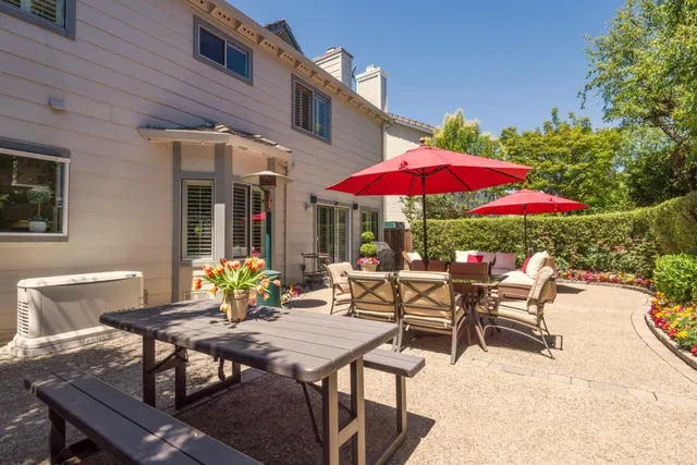 a view of a house with a patio and a yard