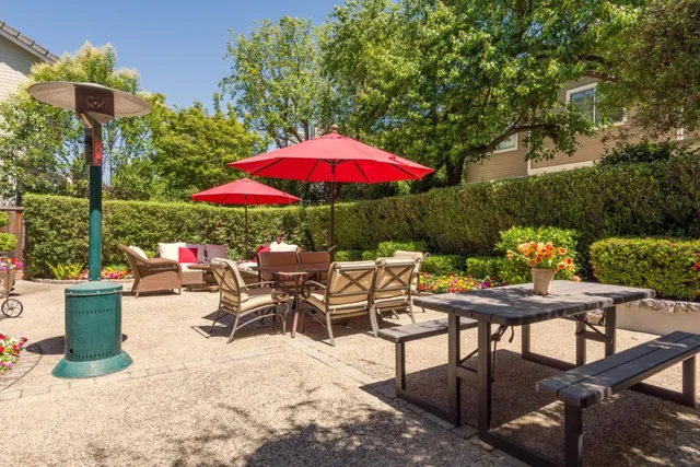 a view of a house with a small yard and wooden fence