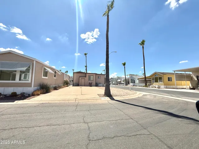 a large white kitchen with a stove a sink and chandelier