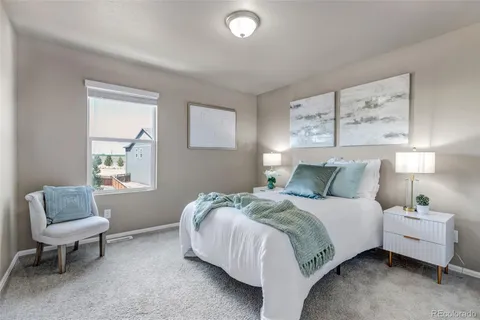 a bed room with a bed and a chair