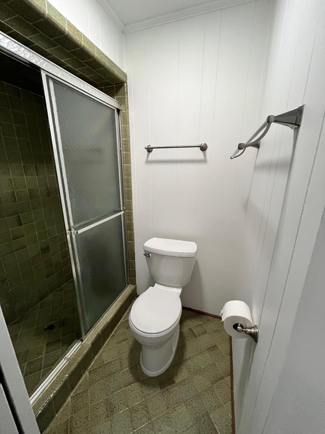 3808 Oak Park Road Raleigh, NC 27612 - Photo 17 of 19 a white toilet sitting next to a shower