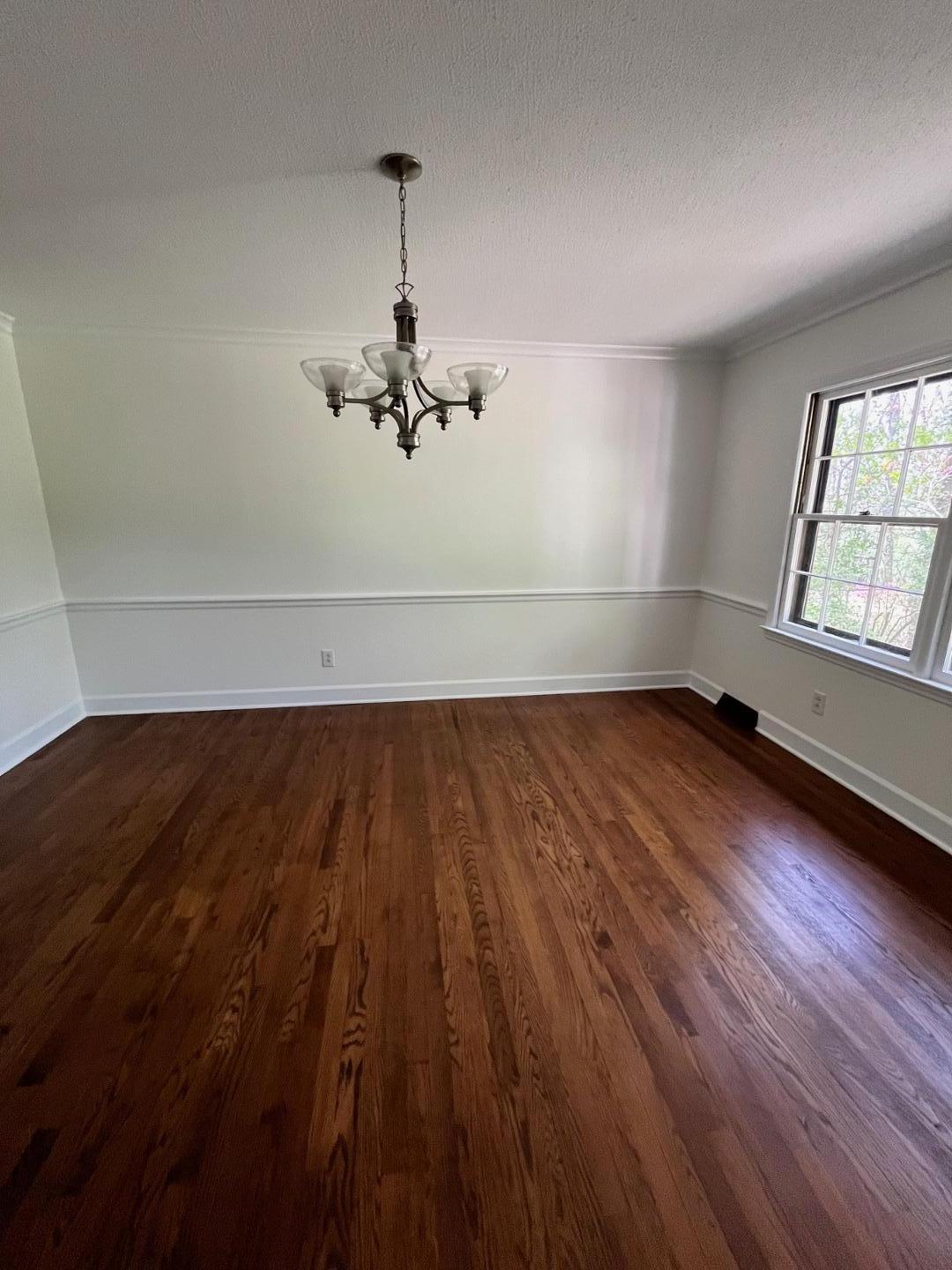 3808 Oak Park Road Raleigh, NC 27612 - Photo 6 of 19 wooden floor in an empty room with a window