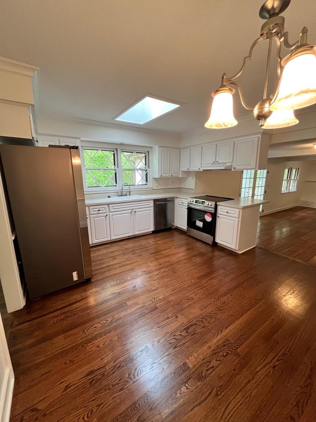 3808 Oak Park Road Raleigh, NC 27612 - Photo 8 of 19 a kitchen with stainless steel appliances a refrigerator and a stove