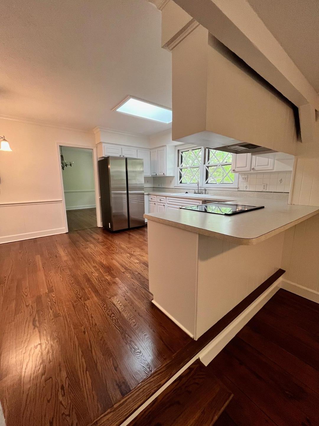 3808 Oak Park Road Raleigh, NC 27612 - Photo 9 of 19 a kitchen with kitchen island a sink appliances and cabinets