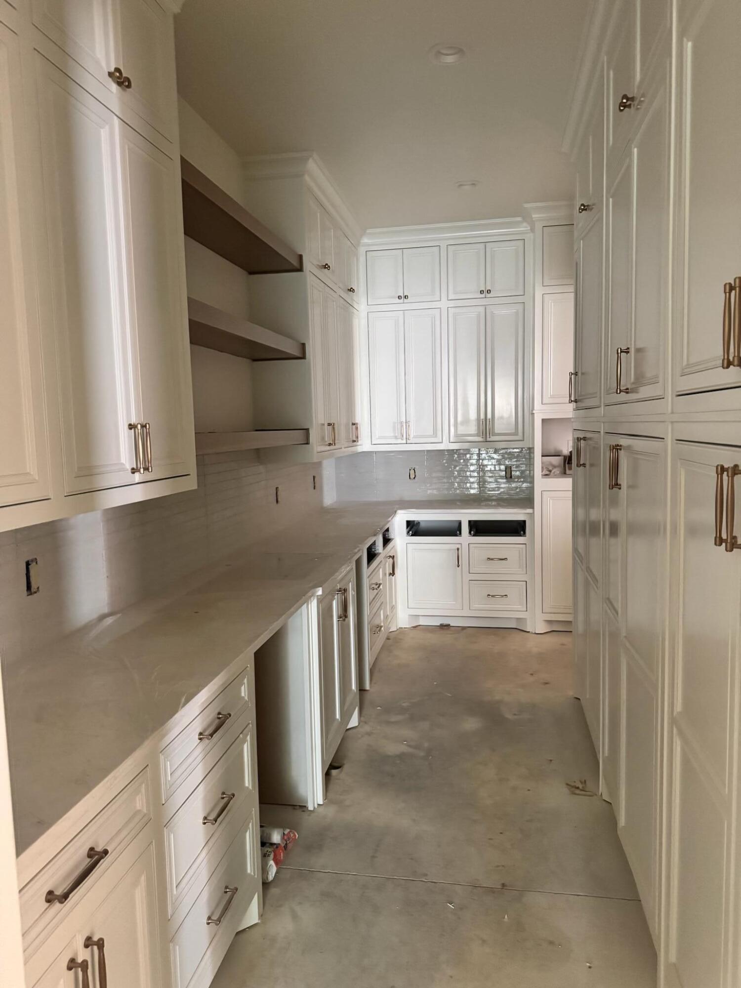 4007 150th Street Lubbock, TX 79423 - Photo 12 of 20 a kitchen with kitchen island white cabinets and refrigerator