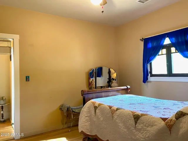 a bedroom with bed and window