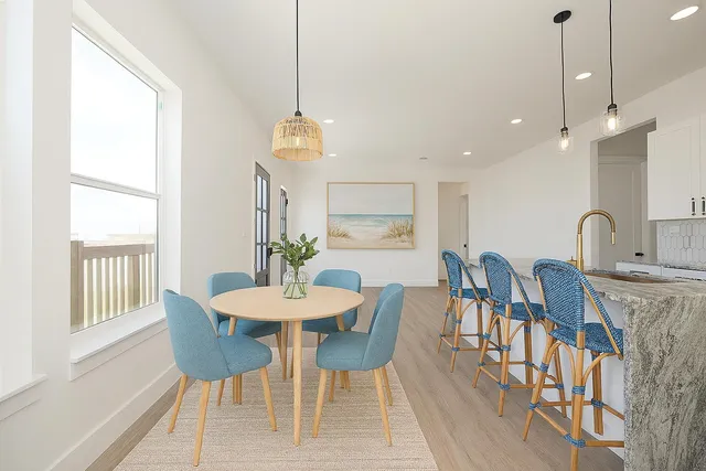 a view of a dining room with furniture window and wooden floor