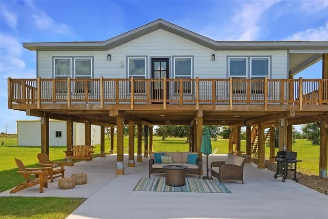 a view of a house with a patio and a garden