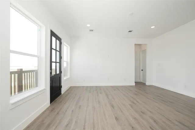 wooden floor in an empty room with a window
