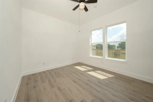 wooden floor in an empty room with a window