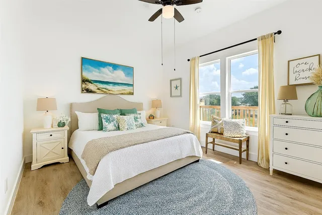 a bedroom with a bed and a large window