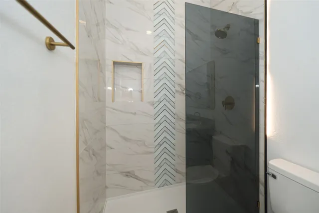 a bathroom with a shower and a sink