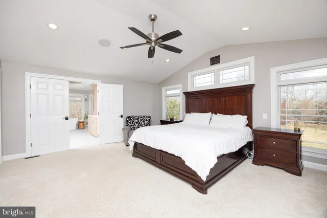 a white bath tub sitting in a room next to a window