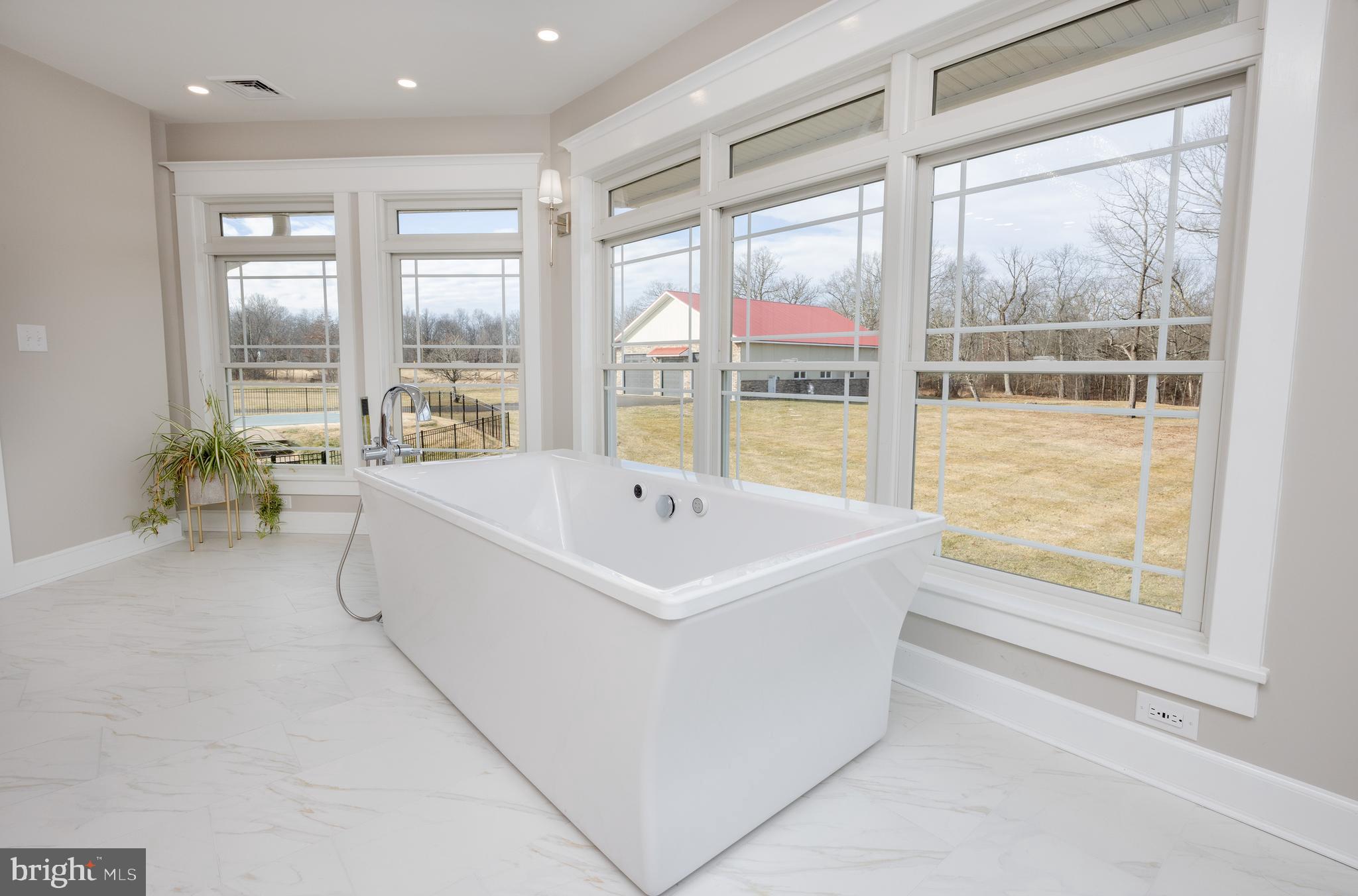 6469 Groveland Road Pipersville, PA 18947 - Photo 20 of 53 a white bath tub sitting in a room next to a window