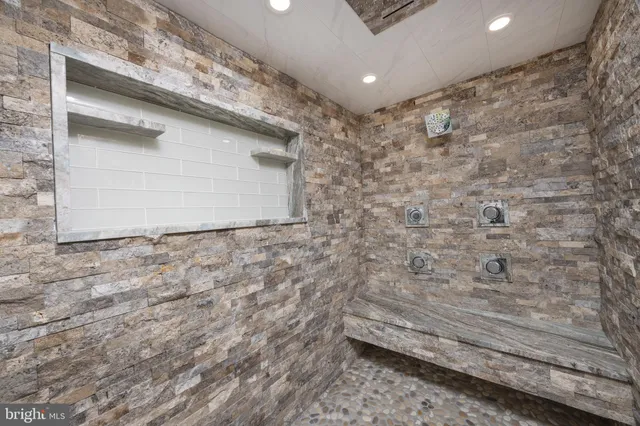 an empty room with windows and ceiling fan