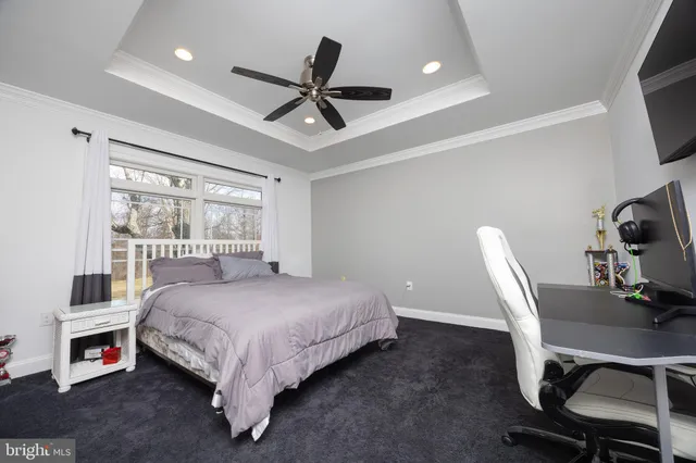 a view of an empty room with a flat screen tv and windows