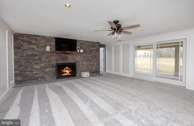 a view of a livingroom with furniture and a ceiling fan