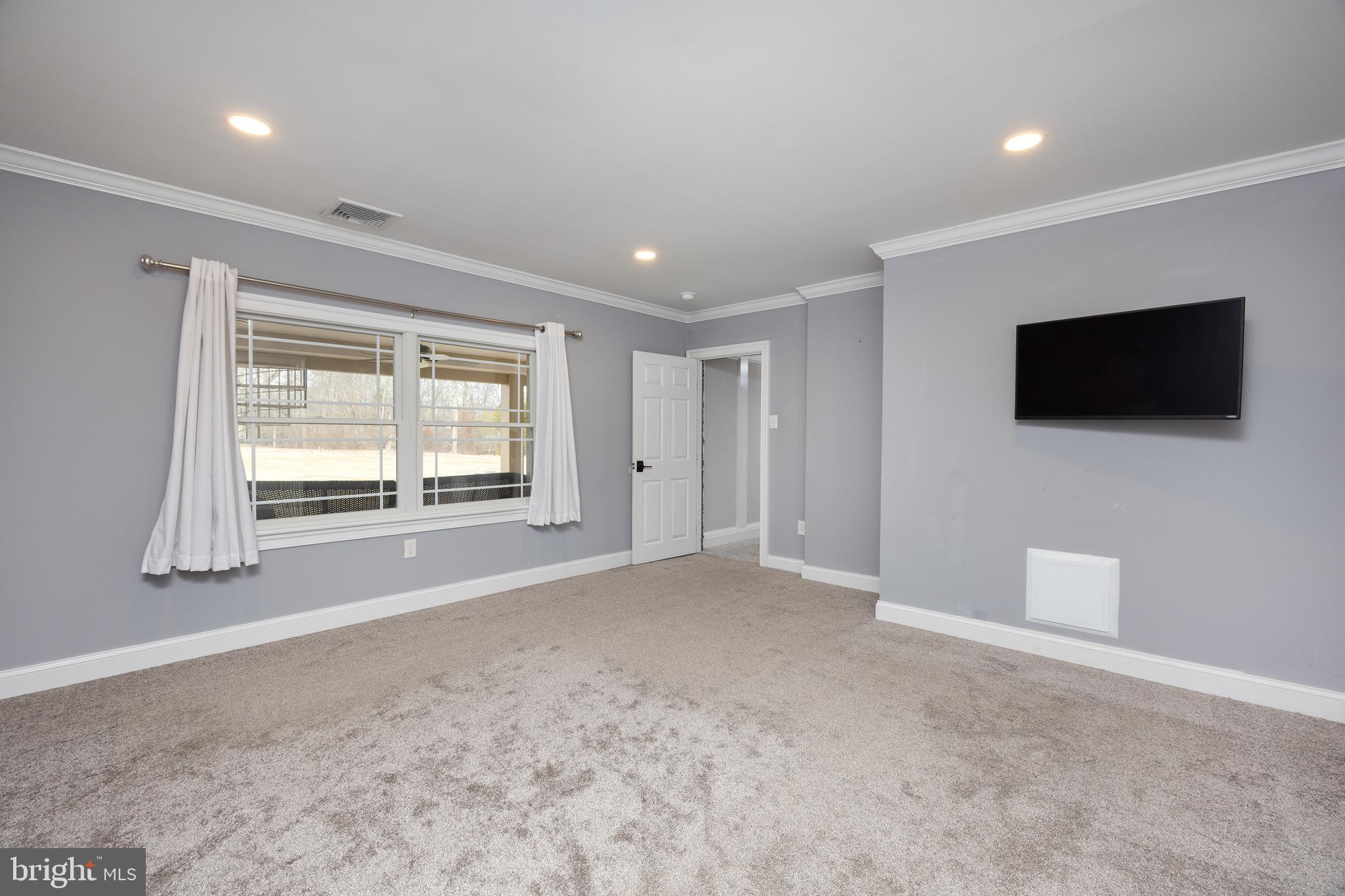 6469 Groveland Road Pipersville, PA 18947 - Photo 41 of 53 a view of an empty room with a flat screen tv and windows