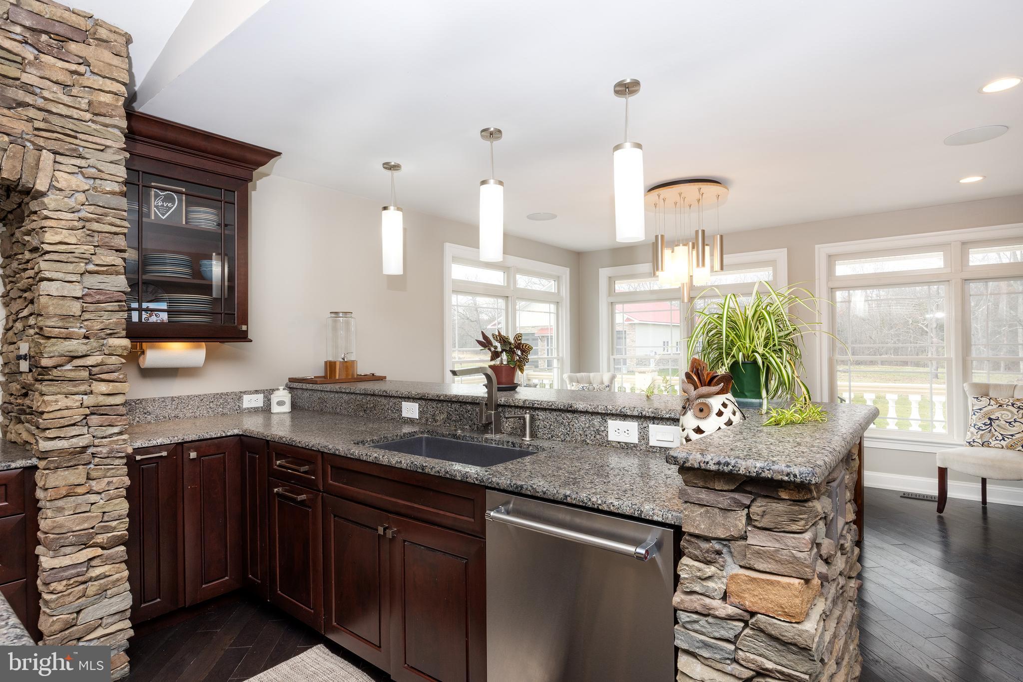 6469 Groveland Road Pipersville, PA 18947 - Photo 7 of 53 a kitchen with a sink and wooden cabinets