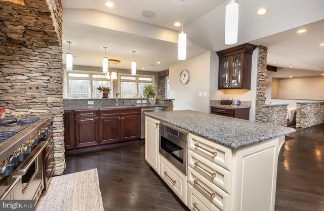 a stove top oven sitting inside of a kitchen