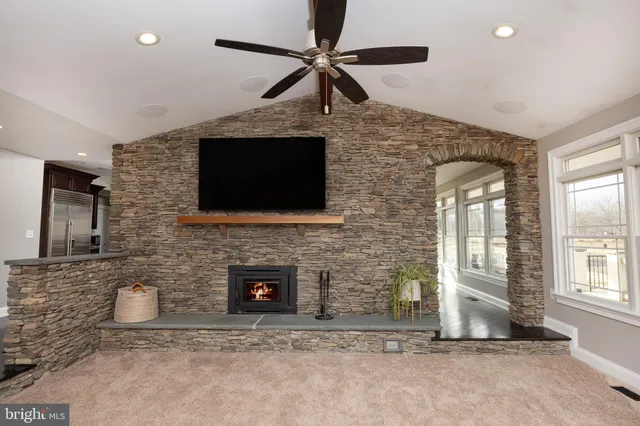 a living room with furniture a flat screen tv and a fireplace