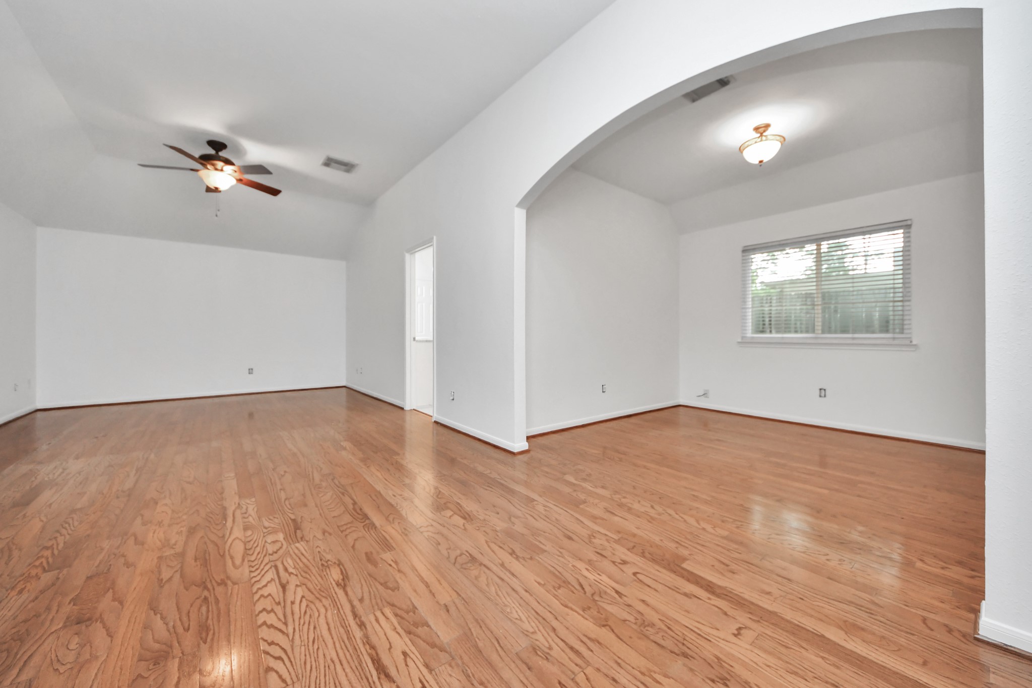 5622 Pineaster Pointe Lane Spring, TX 77379 - Photo 20 of 40 Spacious room featuring wood-finish flooring, vaulted ceilings, and a ceiling fan with integrated lighting
