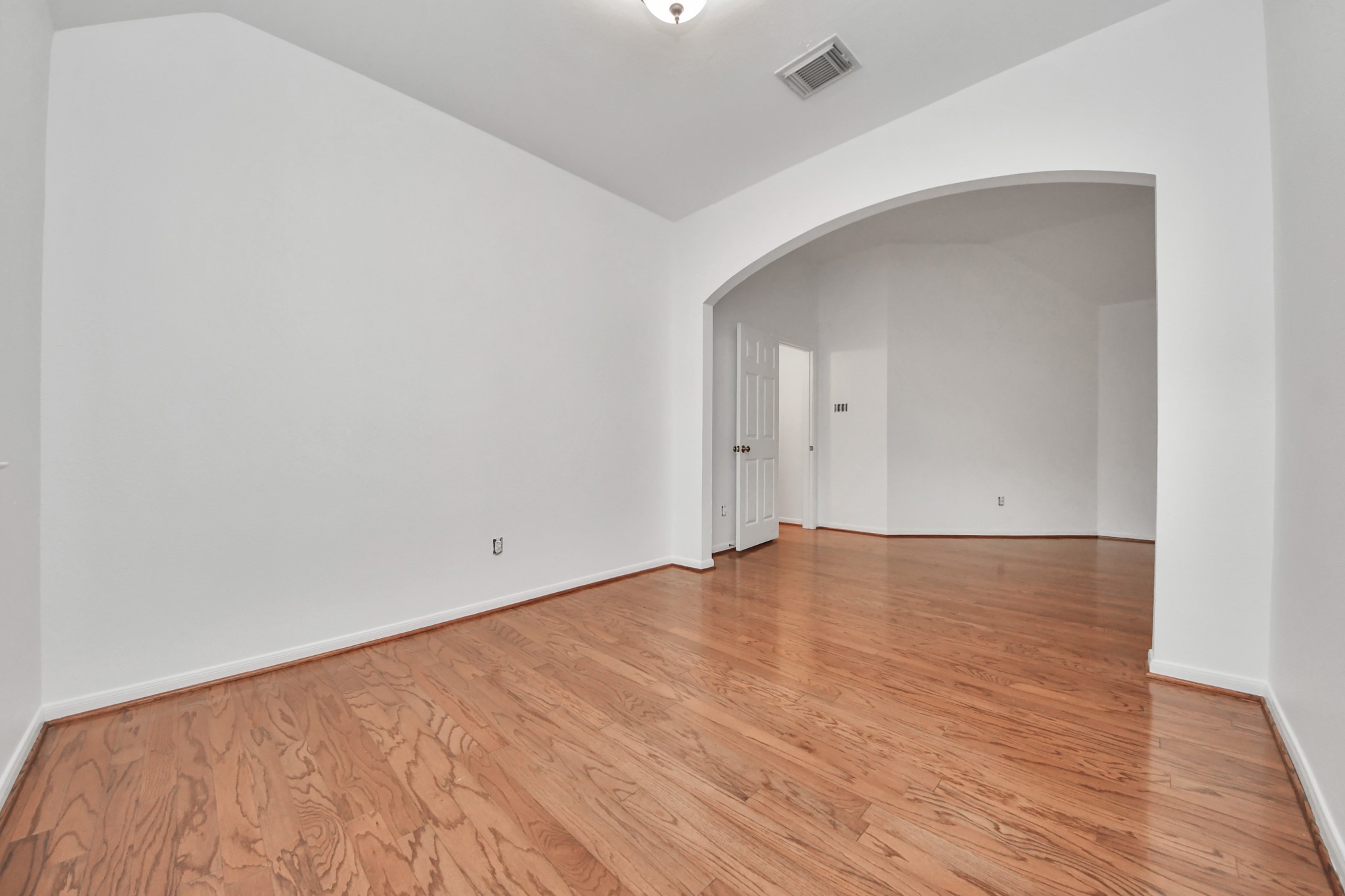 5622 Pineaster Pointe Lane Spring, TX 77379 - Photo 21 of 40 Spacious interior featuring wood-finish flooring, white walls, and a recessed ceiling light