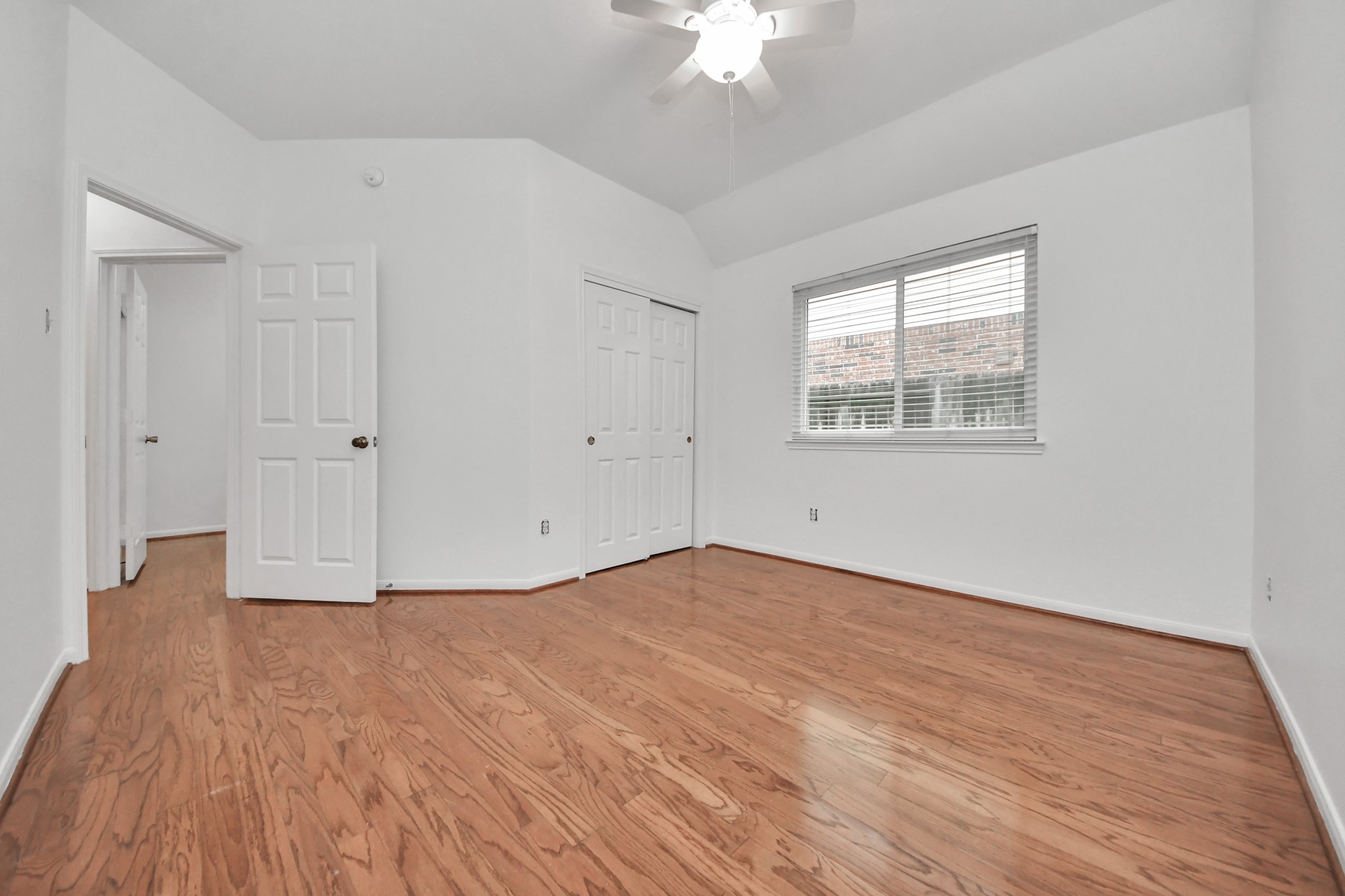 5622 Pineaster Pointe Lane Spring, TX 77379 - Photo 29 of 40 Room featuring wood-finish flooring, a ceiling fan with integrated lighting, and a window with blinds