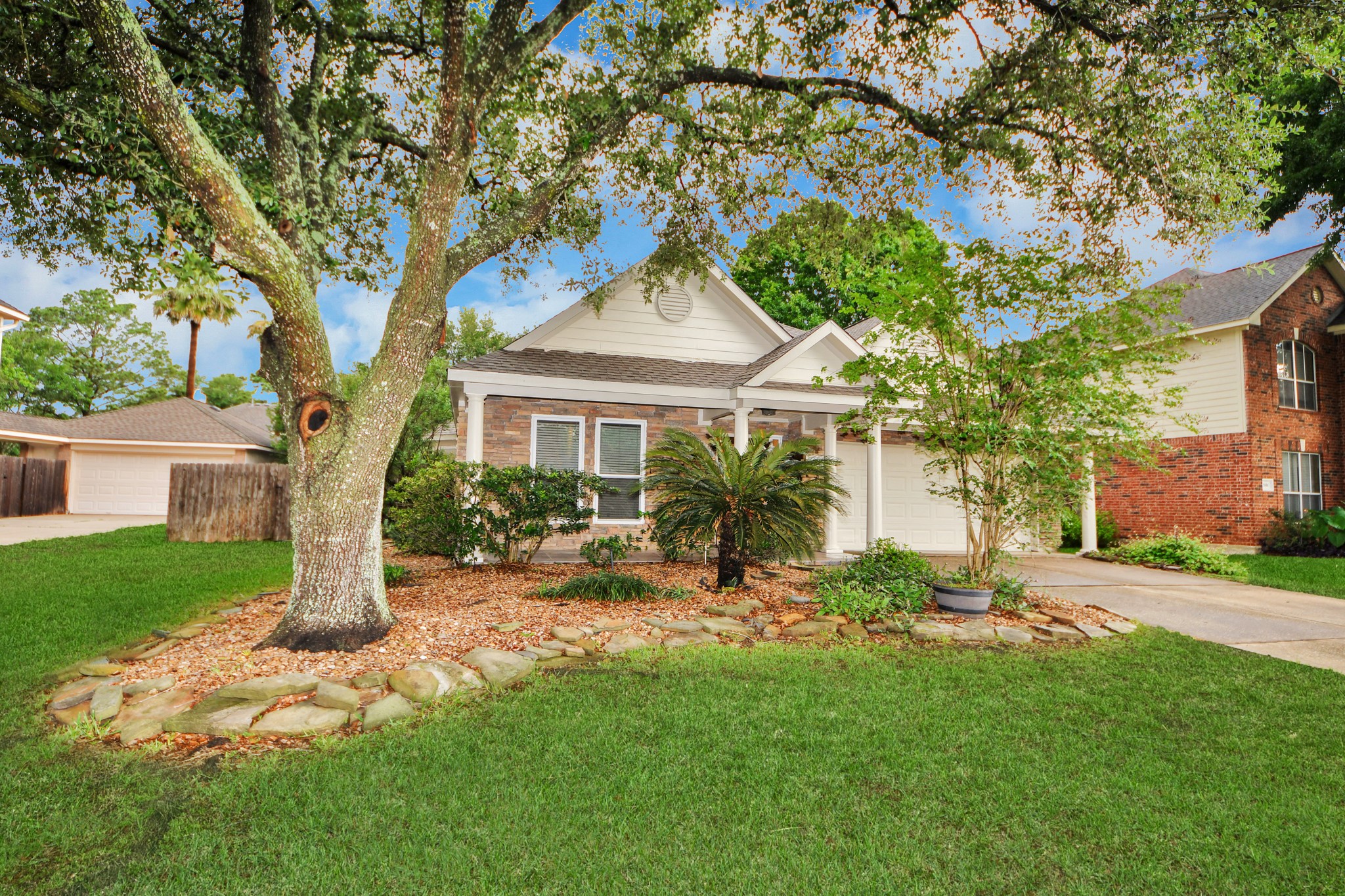 5622 Pineaster Pointe Lane Spring, TX 77379 - Photo 3 of 40 Front exterior featuring a gabled roofline, stone veneer accents, and a covered entry