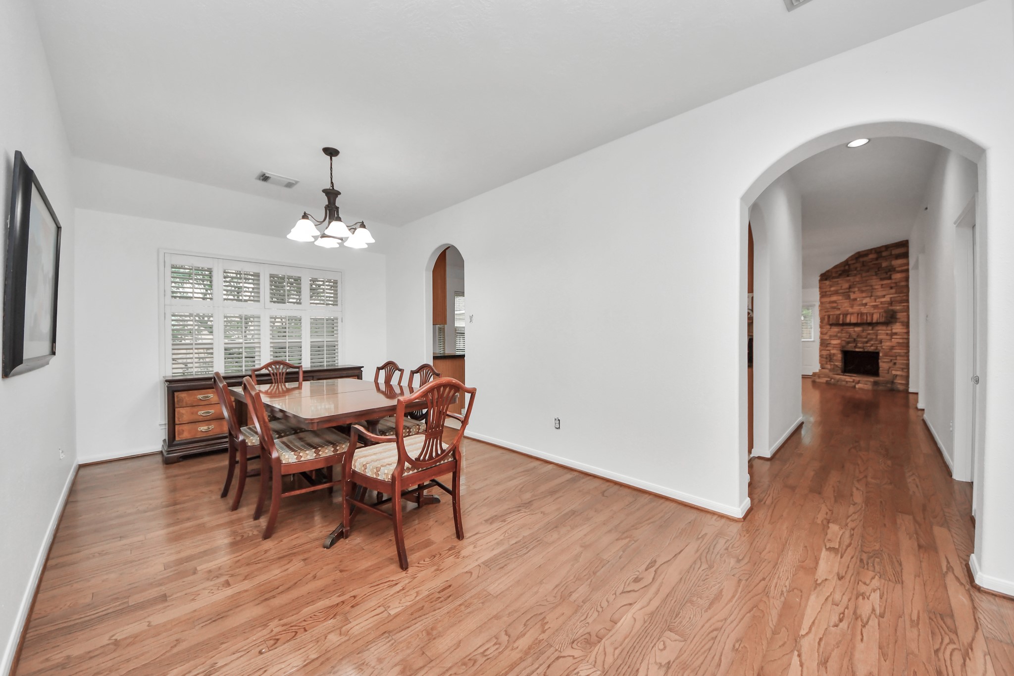 5622 Pineaster Pointe Lane Spring, TX 77379 - Photo 8 of 40 Hardwood flooring extends throughout this room, featuring a white ceiling with a four-light chandelier