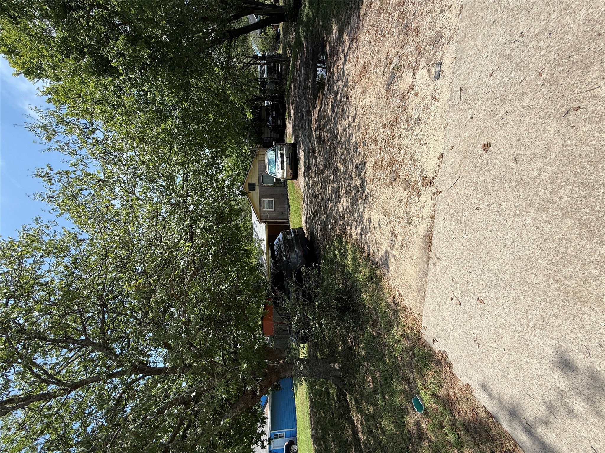 a view of a yard with wooden fence
