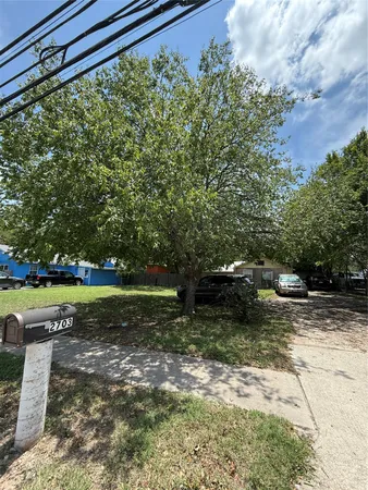 a view of a backyard with water fountain and trees