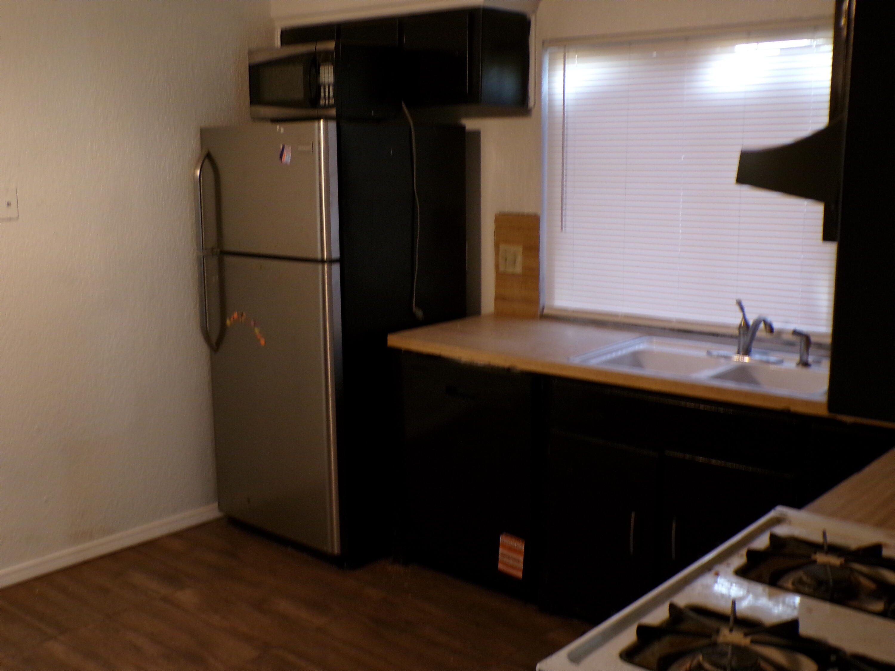 5916 14th Street Lubbock, TX 79416 - Photo 16 of 22 a kitchen with a refrigerator and a sink