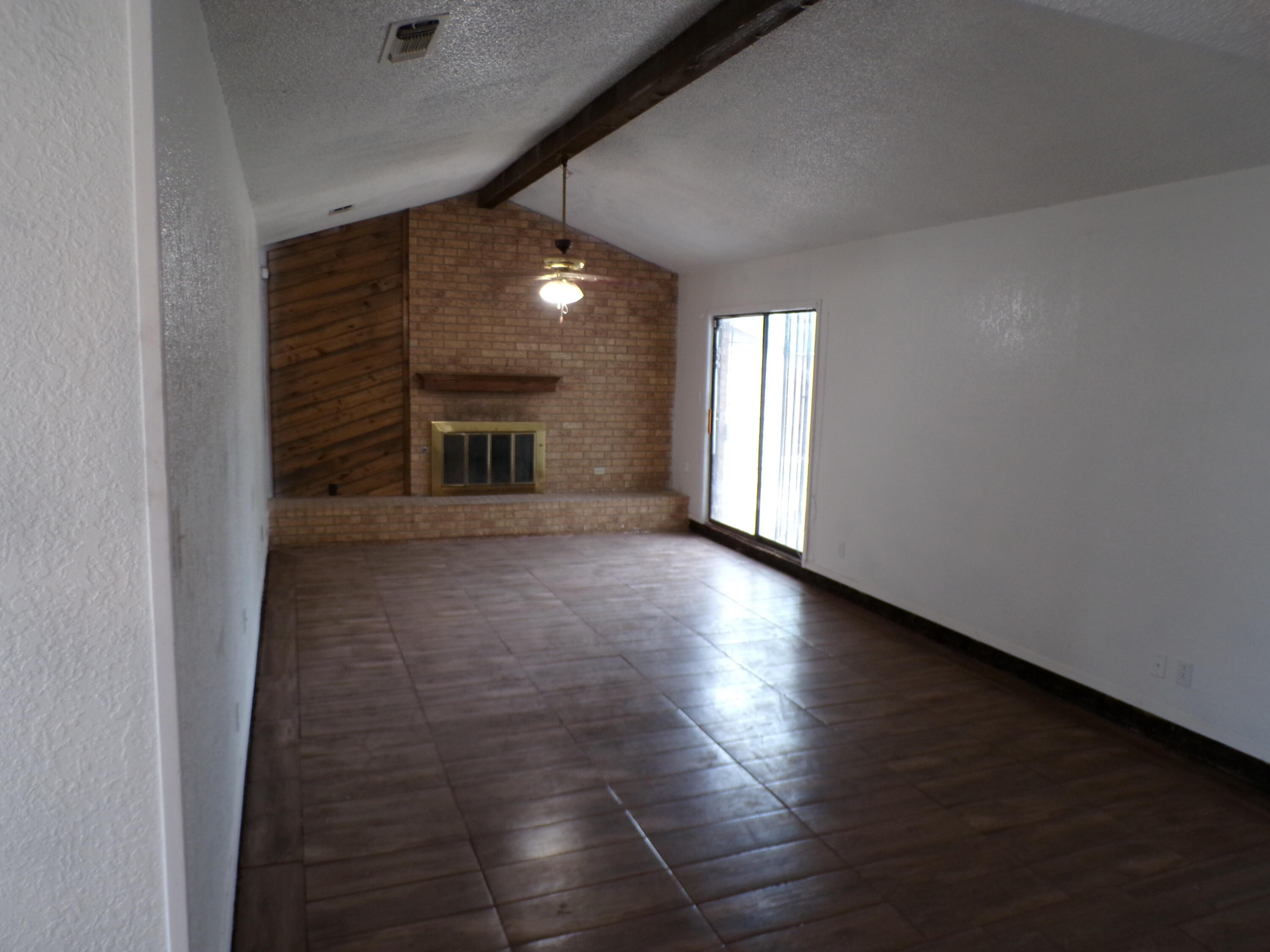 5916 14th Street Lubbock, TX 79416 - Photo 3 of 22 an empty room with windows and fireplace
