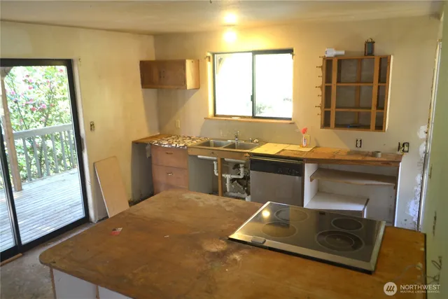 a view of a kitchen with a sink and a fireplace