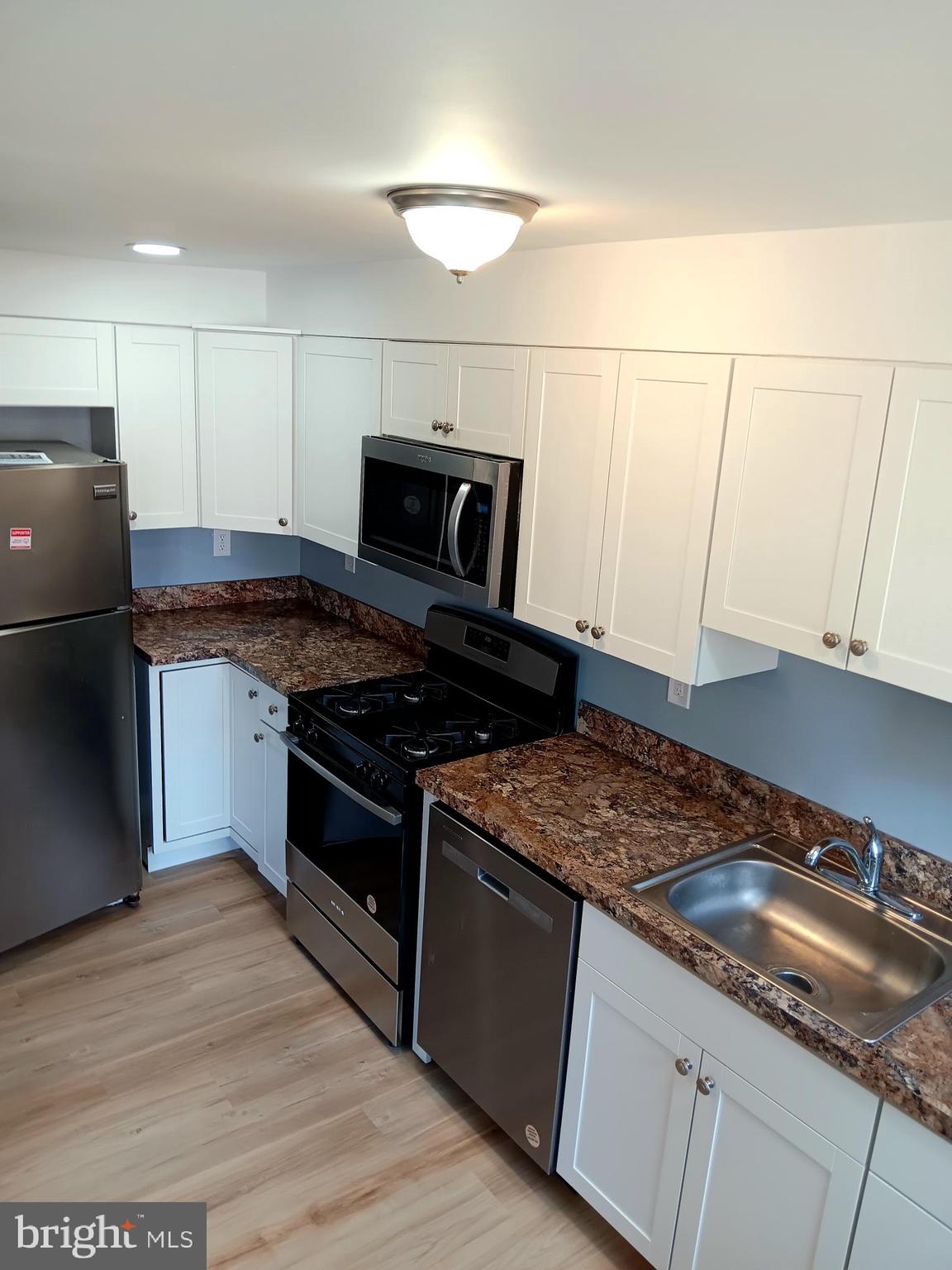 26 East Lynbrook Road Collingdale, PA 19023 - Photo 8 of 21 a kitchen with granite countertop a sink and a stove