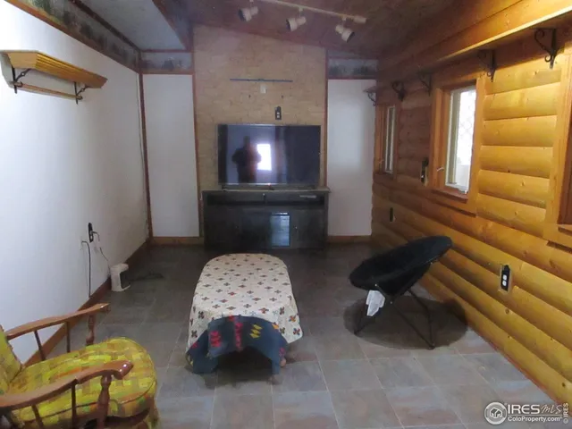 a view of a porch with furniture and a yard