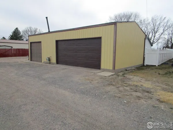 a view of garage with parked cars