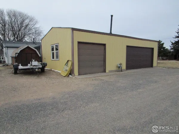 a kitchen with stainless steel appliances granite countertop a refrigerator a sink dishwasher a stove with wooden cabinets and floor