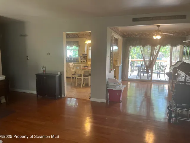 a view of a living room with furniture and wooden floor