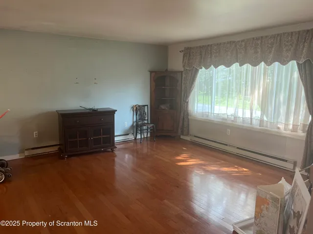 a view of room with window and hardwood floor