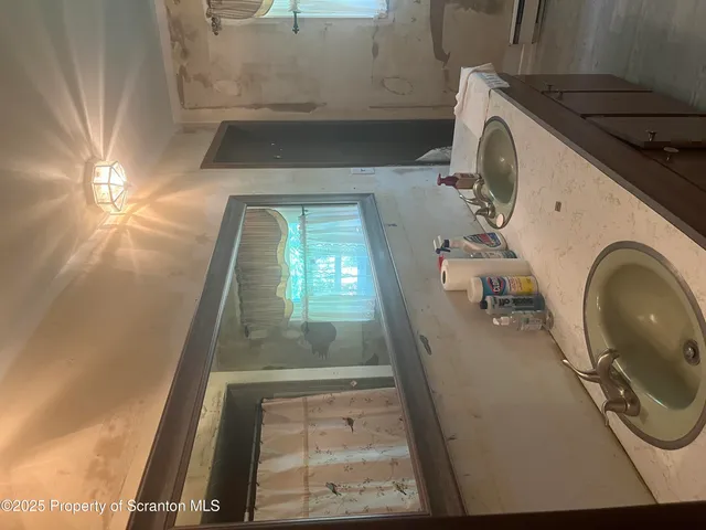a bathroom with a shower a mirror and a shower