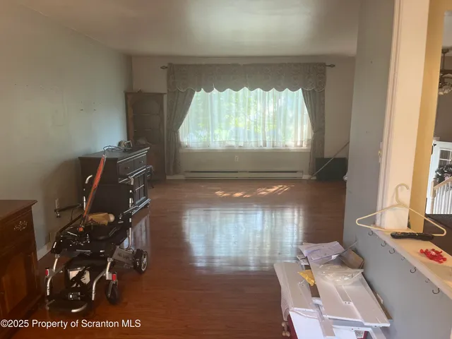 a kitchen with stainless steel appliances granite countertop a stove a refrigerator a dining table and chair