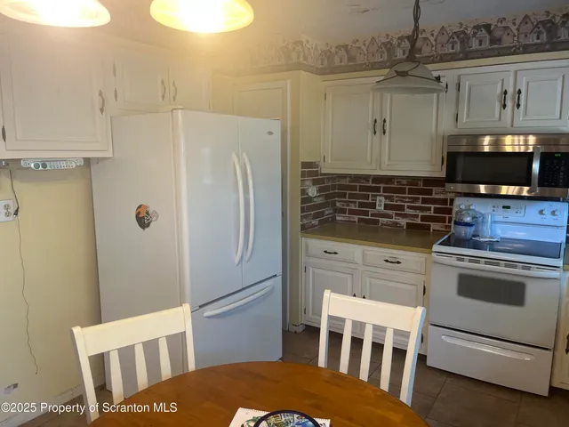 a kitchen with stainless steel appliances a refrigerator stove and microwave